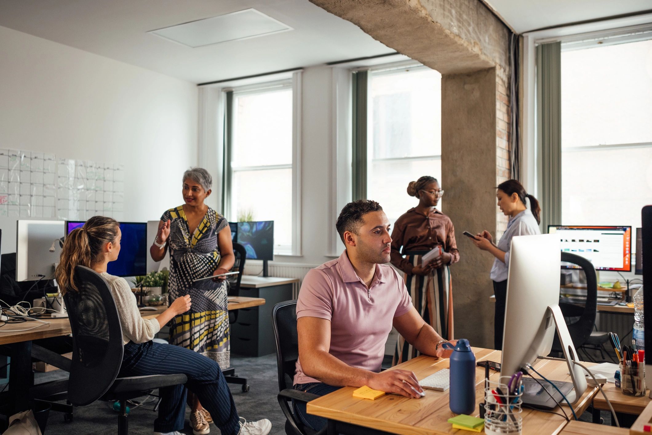 Colleagues collaborating in a modern software office